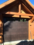 embossed dark wood single residential garage door installation