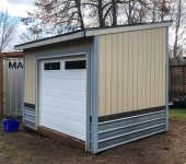 Small storage shed garage door installation